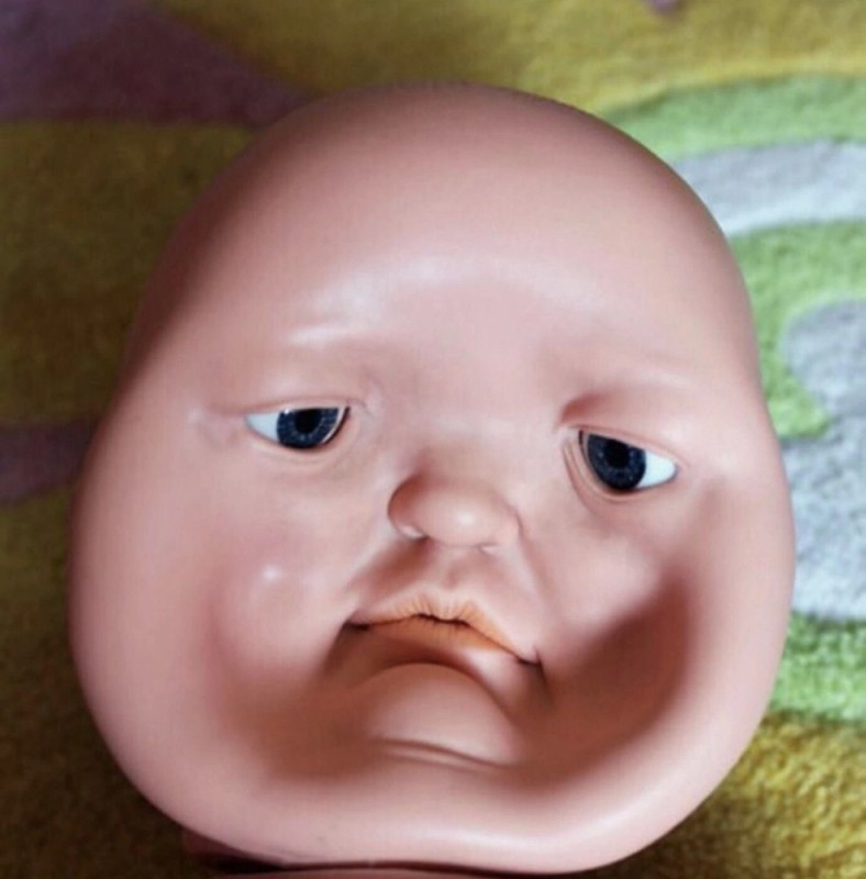 Create meme: a doll with a concave face, toots down, a baby with a depressed face