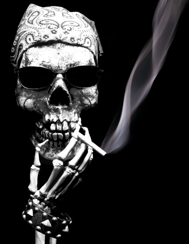 Create meme: skull with cigarette, cool skulls, skeleton on a black background