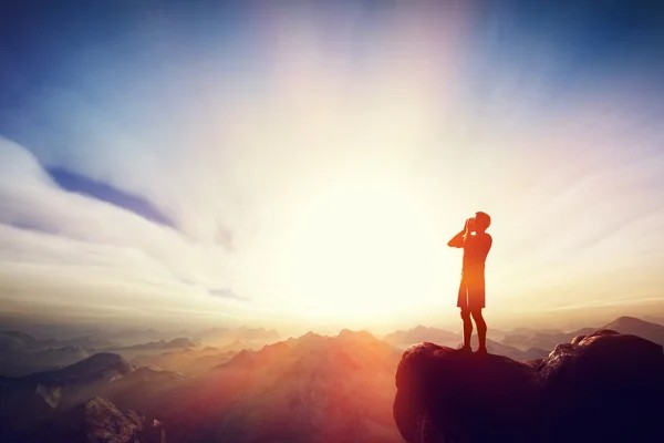 Create meme: at the top of the mountain, mountains at sunset, a man on top of a mountain